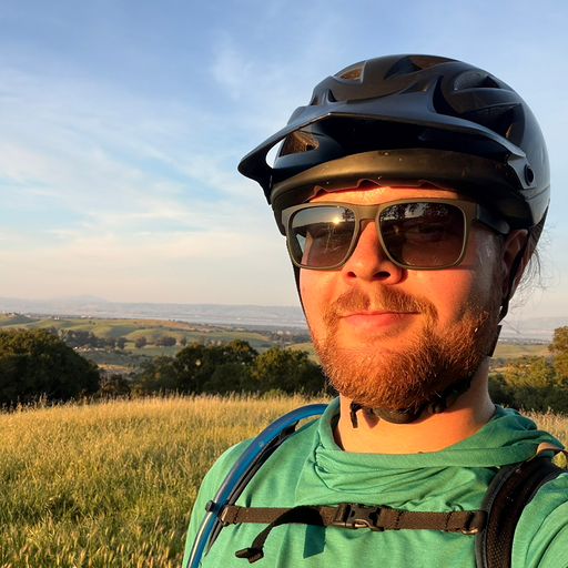 Alex wearing a mountain-bike helmet outdoors